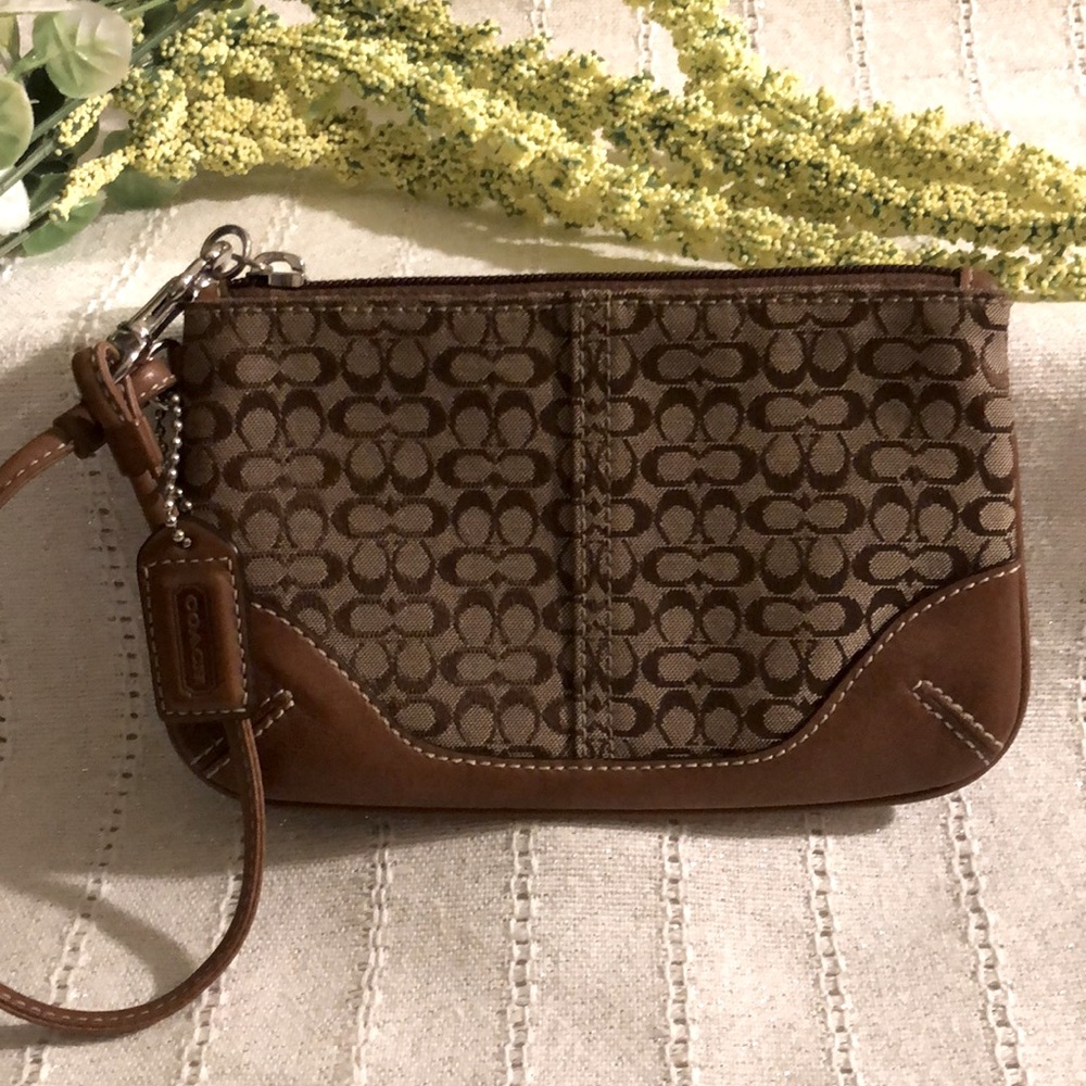 Coach signature canvas and brown leather wristlet.